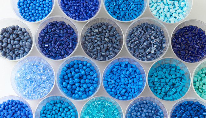 A variety of blue plastics in clear dishes illustrating UWM's Plastic and Elastomer Engineering Program