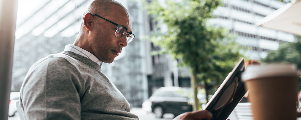 Human resource manager sits outside with laptop studying for his class in HR and SHRM at UWM School of Continuing Education.