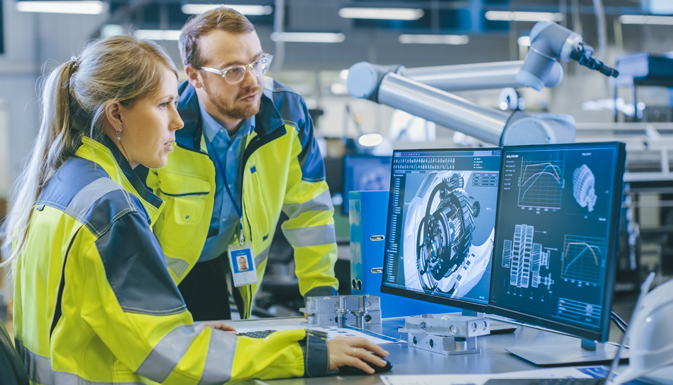 Industrial engineers analyzing 3D gear design and performance data on a computer screen in a modern manufacturing facility with robotic technology.